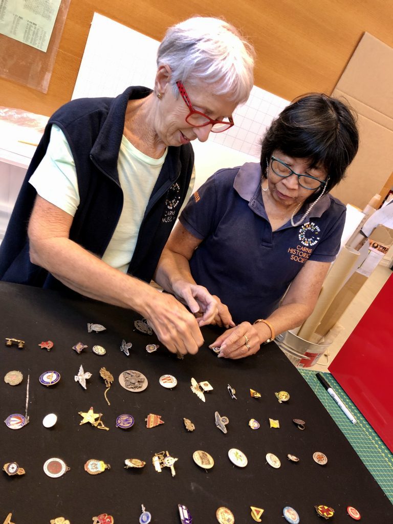 Museum volunteers working on badges