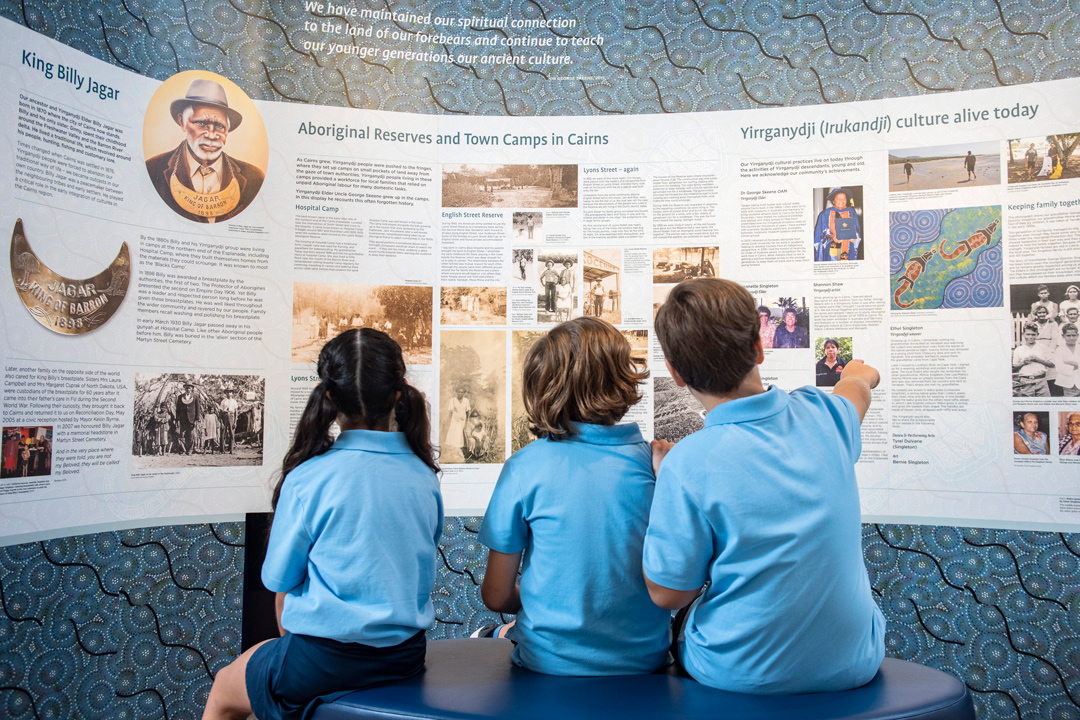 3 children reading about Cairns first nations people at a museum exhibition