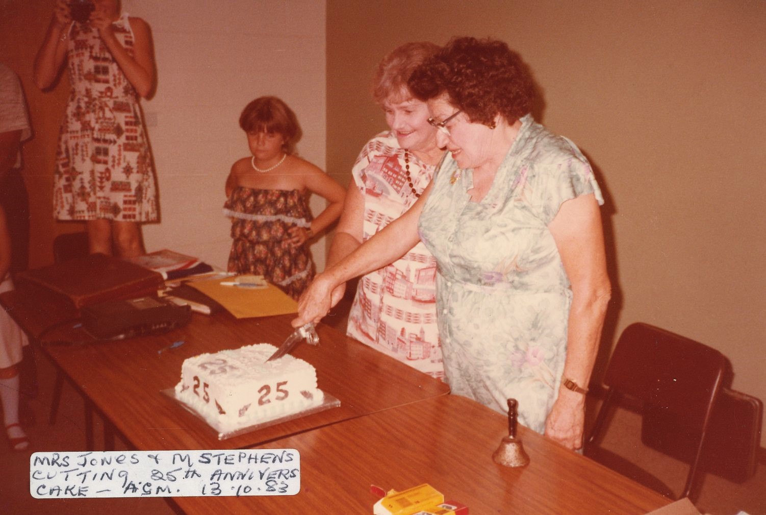 Cairns historical society cutting cake for 25 year anniversary