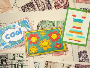 handmade postcards on background of vintage stamps